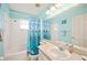 Bright bathroom featuring a tub with shower and a blue dolphin-themed shower curtain at 603 Reflections Loop, Winter Haven, FL 33884