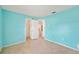 Bright bedroom with neutral tile, light blue walls, ceiling fan, and doorways to other rooms at 603 Reflections Loop, Winter Haven, FL 33884