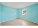 Well-lit bedroom with tile flooring, light blue walls, and a bright window providing natural light at 603 Reflections Loop, Winter Haven, FL 33884