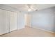 Cozy bedroom with tile flooring, light blue walls, and a double door closet for ample storage at 603 Reflections Loop, Winter Haven, FL 33884