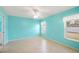 Spacious bedroom featuring neutral tile flooring, light blue walls, and bright windows with light curtains at 603 Reflections Loop, Winter Haven, FL 33884