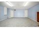 Expansive bonus room with tiled floors, neutral paint, ceiling fan, and multiple access doors at 603 Reflections Loop, Winter Haven, FL 33884