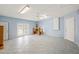 Large bonus room featuring tiled floors, neutral paint, ceiling fan, and access to the backyard at 603 Reflections Loop, Winter Haven, FL 33884