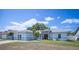 Charming single-story home featuring a well-maintained lawn and mature landscaping under a sunny, partly cloudy sky at 603 Reflections Loop, Winter Haven, FL 33884