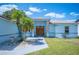 Charming single-story home with a well-manicured lawn, palm tree, and stylish stone accents at 603 Reflections Loop, Winter Haven, FL 33884