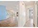 Hallway view showcasing seamless transition into a naturally lit bedroom and a spacious living area with tile floors at 603 Reflections Loop, Winter Haven, FL 33884