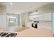 Bright kitchen featuring white cabinets, modern appliances, and a cozy breakfast nook with plenty of natural light at 603 Reflections Loop, Winter Haven, FL 33884