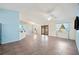 Spacious living room with tile flooring, ceiling fan, and natural light streaming through the windows and double doors at 603 Reflections Loop, Winter Haven, FL 33884
