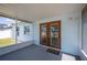 Enclosed back patio featuring wood-framed glass doors that provide access to backyard at 603 Reflections Loop, Winter Haven, FL 33884