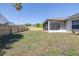 A spacious backyard with a wood fence and screen enclosed porch at 633 Heather Glen Loop, Winter Haven, FL 33884