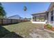 A large grass backyard with a wooden privacy fence and screened lanai at 633 Heather Glen Loop, Winter Haven, FL 33884