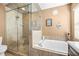 Bathroom highlighting glass shower, soaking tub, decorative lighting, and tile floors at 633 Heather Glen Loop, Winter Haven, FL 33884