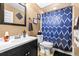 Charming bathroom with a patterned shower curtain, framed mirror, and a vanity offering a clean and stylish space at 633 Heather Glen Loop, Winter Haven, FL 33884