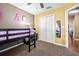 This bedroom features carpeted floors, a ceiling fan, and a closet with white doors, offering comfort and storage at 633 Heather Glen Loop, Winter Haven, FL 33884
