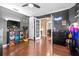 Bedroom featuring wooden floors, television, ceiling fan, and playful decor at 633 Heather Glen Loop, Winter Haven, FL 33884