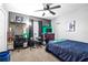 Bedroom boasts a ceiling fan, carpet, neutral gray walls, and musical instruments, perfect for a growing musician at 633 Heather Glen Loop, Winter Haven, FL 33884