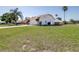 Spacious single-story house featuring a lush lawn, a wide driveway, and mature landscaping at 633 Heather Glen Loop, Winter Haven, FL 33884