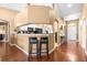 Open-concept home with hardwood floors, neutral walls, and a clear view from the kitchen to the foyer at 633 Heather Glen Loop, Winter Haven, FL 33884