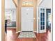 Bright foyer features wood floors, a patterned rug, and a clear view of adjacent living spaces at 633 Heather Glen Loop, Winter Haven, FL 33884