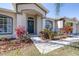 Welcoming entrance showcasing neat landscaping, an arched doorway, and an inviting front door at 633 Heather Glen Loop, Winter Haven, FL 33884