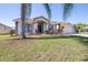 Inviting single-story house with a manicured lawn, trimmed shrubs, and a welcoming front entrance at 633 Heather Glen Loop, Winter Haven, FL 33884