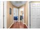 Hallway showcasing wooden floors and views of bedrooms with gray walls and carpet floors at 633 Heather Glen Loop, Winter Haven, FL 33884