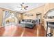 Cozy living room with hardwood floors, a comfortable sectional sofa, and sliding glass doors to the patio at 633 Heather Glen Loop, Winter Haven, FL 33884