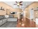 Spacious living room featuring hardwood floors, neutral walls, a cozy gray sectional, and an open layout at 633 Heather Glen Loop, Winter Haven, FL 33884