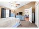 Main bedroom with ceiling fan, closet, television, carpet floors, and living room view at 633 Heather Glen Loop, Winter Haven, FL 33884