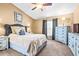 Cozy main bedroom with vaulted ceiling, carpet floors, and custom blue painted dresser and nightstands at 633 Heather Glen Loop, Winter Haven, FL 33884