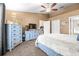 Carpeted main bedroom with walk-in closet, television, ceiling fan, and ensuite bathroom at 633 Heather Glen Loop, Winter Haven, FL 33884