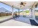 Covered patio with ceiling fan offers a relaxing outdoor space overlooking a well-maintained, fenced backyard at 633 Heather Glen Loop, Winter Haven, FL 33884