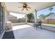 Relaxing screened patio with fan overlooking a spacious backyard, ideal for outdoor living and entertaining at 633 Heather Glen Loop, Winter Haven, FL 33884