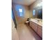 Bathroom featuring a vanity with a sink, toilet, and window, all in a well-lit space at 668 Jamaica Cir, Lakeland, FL 33803