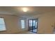 Bedroom features sliding glass doors, window, and neutral walls, creating a serene atmosphere at 668 Jamaica Cir, Lakeland, FL 33803