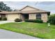 Charming single-story home with a brick facade, attached garage, and well-maintained front lawn at 668 Jamaica Cir, Lakeland, FL 33803