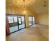 Open living area with large sliding doors leading to an enclosed patio, enhancing natural light at 668 Jamaica Cir, Lakeland, FL 33803