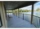 Covered patio with seating overlooks peaceful water views at 668 Jamaica Cir, Lakeland, FL 33803