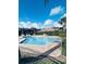 Sparkling community pool surrounded by lush landscaping and comfortable seating at 668 Jamaica Cir, Lakeland, FL 33803
