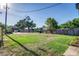 Large grassy backyard with mature trees, offering plenty of space for outdoor activities and relaxation at 737 Johnson Ave, Lakeland, FL 33801