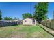Fenced backyard with grass and tree coverage provides privacy for quiet outdoor enjoyment at 737 Johnson Ave, Lakeland, FL 33801