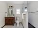 Charming bathroom features wood vanity, shiplap walls, and walk-in shower with black and white tile at 737 Johnson Ave, Lakeland, FL 33801