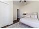 Bedroom featuring hardwood floors, ceiling fan, and closet with paneled doors at 737 Johnson Ave, Lakeland, FL 33801