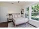 Bedroom with hardwood floors, natural light from window, and neutral walls at 737 Johnson Ave, Lakeland, FL 33801