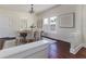 Elegant dining room with chandelier, hardwood floors, and plenty of natural light. Living room in background at 737 Johnson Ave, Lakeland, FL 33801