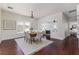 Dining area view with chandelier, hardwood floors, and an open layout leading to the living room at 737 Johnson Ave, Lakeland, FL 33801
