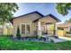A cozy single-story home featuring a covered porch with stylish accents and manicured landscaping at 737 Johnson Ave, Lakeland, FL 33801