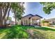 Charming single-story home with a covered porch, lush green lawn, and well-manicured landscaping at 737 Johnson Ave, Lakeland, FL 33801