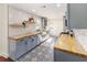 Stylish kitchen features custom cabinets, floating shelves, butcher block counters, and stainless steel farmhouse sink at 737 Johnson Ave, Lakeland, FL 33801