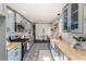 Charming kitchen with modern cabinets, stainless appliances, butcher block countertops, and decorative tile floor at 737 Johnson Ave, Lakeland, FL 33801